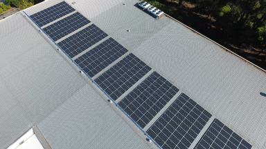 Aerial shot of a chocolate factory with solar panels on the roof